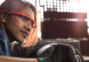woman wearing safety glasses in manufacturing environment